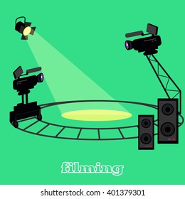 Film shootings camera and projector. Equipment for filming, professional camera on circular rails, it is glowing a bright spotlight and speakers for sound isolated in studio green. Vector illustration