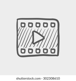 Film strip icon for web and mobile. Hand drawn vector dark grey icon on light grey background.