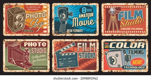 Film studio rusty metal plates, movie retro vector posters with vintage photo and video camera, film reel and clapper. Cinema, cinematography entertainment industry ferruginous cards, old camcorders