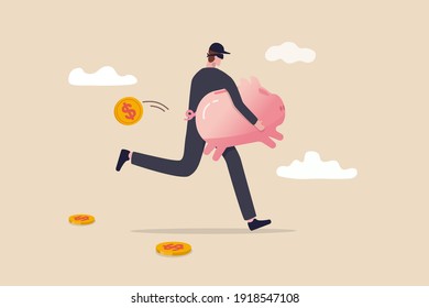 Financial crime, stealing money, investment risk or banking security concept, young man with black mask bandit costume or thief stealing or carrying wealthy piggy bank away with dollar coins falling.