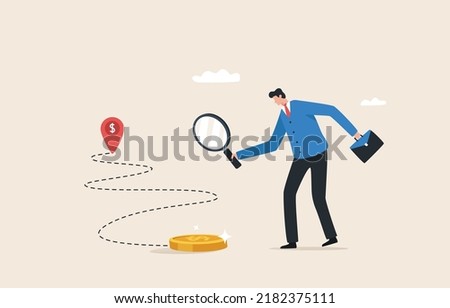 Financial navigation. Path to financial success. Earning extra income or increasing salary. direction of the company growth. Businessman holding a magnifying glass to search and track the trace money.