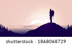 Find meaning in life - Silhouette of backpacker on hilltop watching epic landscape and sunrise. 