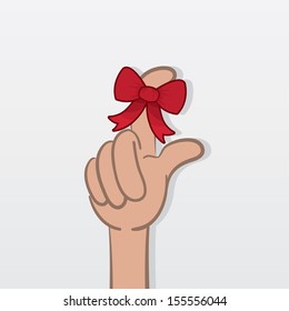 Finger with tied red bow as a reminder 