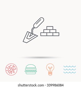 Finishing icon. Spatula with bricks sign. Global connect network, ocean wave and burger icons. Lightbulb lamp symbol.