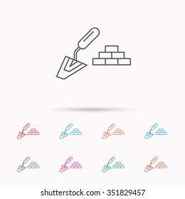 Finishing icon. Spatula with bricks sign. Linear icons on white background.