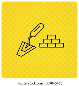 Finishing icon. Spatula with bricks sign. Linear icon on orange background. Vector