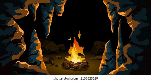 A fire burns in a dark cave. Stones, boulders, stalactites and stalagmites illuminated by the light of a flame. prehistoric housing. stone age scene.