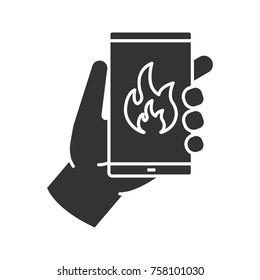 Fire emergency calling glyph icon. Hand holding smartphone with flame. Silhouette symbol. Negative space. Vector isolated illustration