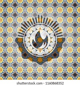 fire icon inside arabesque style badge. arabic decoration.