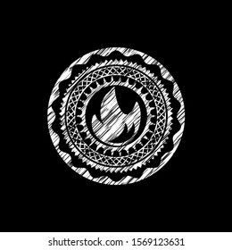 fire icon inside chalkboard emblem written on a blackboard