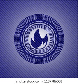 fire icon inside emblem with denim high quality background
