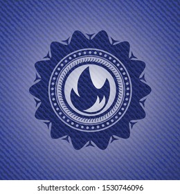fire icon inside emblem with jean background