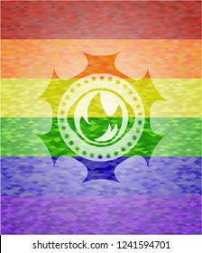 fire icon inside emblem on mosaic background with the colors of the LGBT flag