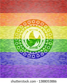 fire icon inside emblem on mosaic background with the colors of the LGBT flag
