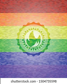 fire icon inside emblem on mosaic background with the colors of the LGBT flag