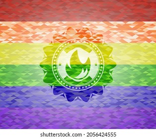 fire icon inside emblem on mosaic background with the colors of the LGBT flag. 