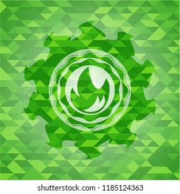 fire icon inside green emblem. Mosaic background