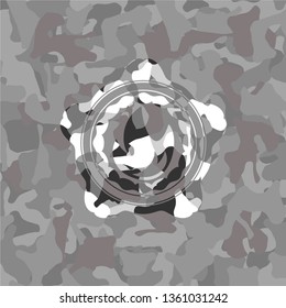 fire icon inside grey camouflaged emblem