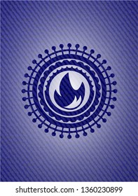 fire icon inside jean or denim emblem or badge background