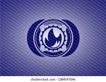 fire icon inside jean or denim emblem or badge background