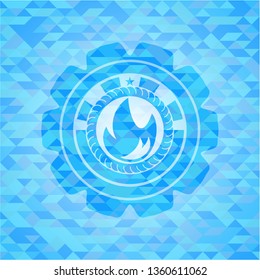 fire icon inside realistic light blue emblem. Mosaic background