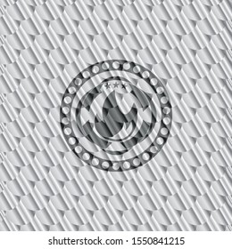 fire icon inside silver shiny badge. Scales pattern. Vector Illustration. Detailed.