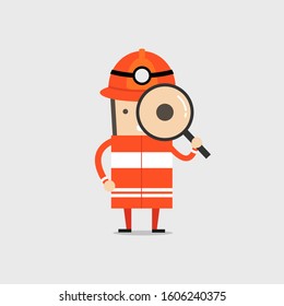 Firefighter holding a magnifying glass. Fireman Man Inspecting with large magnifying glass.