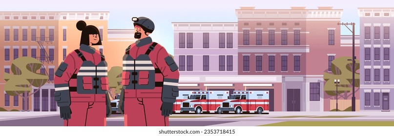 firefighters in uniform standing near fire station building department house facade and red emergency vehicles