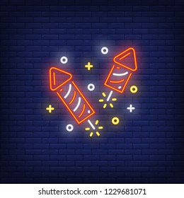 Firework neon sign. Glowing red petards with sparkles on dark blue brick background. Can be used for winter, christmas time, festive