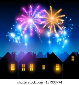 Fireworks lighting up the sky behind town houses.