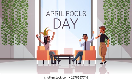 first april fool day mix race businesspeople wearing funny jester hat glasses mustache holiday celebration concept modern office interior horizontal full length vector illustration