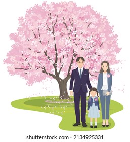 First grade girl and parents standing side by side in front of a cherry tree