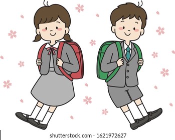 First grader school boy and girl with school bag and uniform under cherry blossom tree