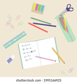 A first grader workspace. School supplies on the table
