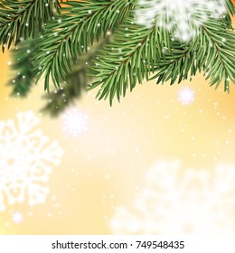 Fir-tree branch on blurred yellow background and snowflakes