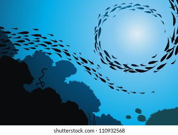 Fish in flight floats among corals against the sun