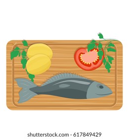 Fish salmon sliced on a kitchen board together with lemon on a wooden planks