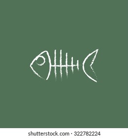 Fish skeleton hand drawn in chalk on a blackboard vector white icon isolated on a green background.