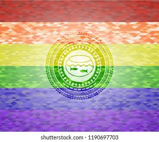 fishbowl with fish icon inside emblem on mosaic background with the colors of the LGBT flag