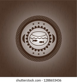 fishbowl with fish icon inside wooden emblem