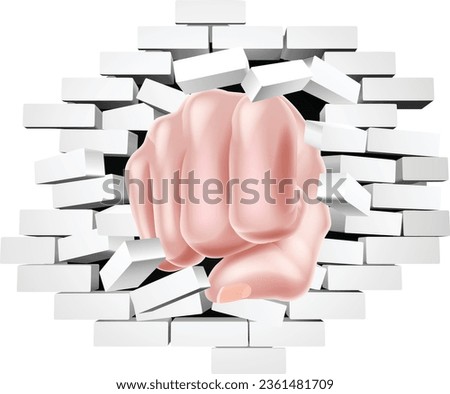 A fist hand punching through a brick wall concept
