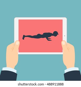 Fitness app for tablet. Hands holding tablet. Abs and arms exercise. How to push-up.