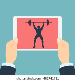 Fitness app for tablet. Weightlifter with barbell. Hands holding tablet. Bodybuilding app.