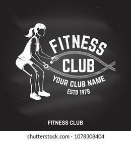 Fitness club badge on the chalkboard. Vector. For fitness centers emblems, gym signs and others related health and gym business. Girl doing exercise with battle ropes.