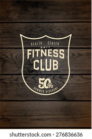 Fitness club badges logos and labels for any use, on wooden background texture