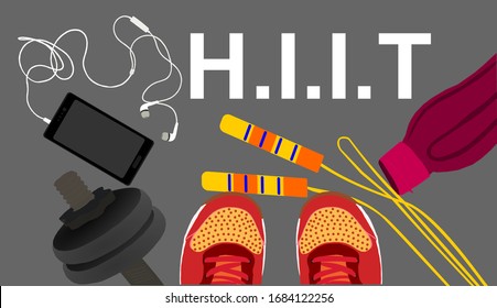 Fitness, healthy and active lifestyles concept. Dumbbells, sport shoes, smart phone,skipping rope with earphone and water bottle on gym floor with word hiit (high intensity interval training)