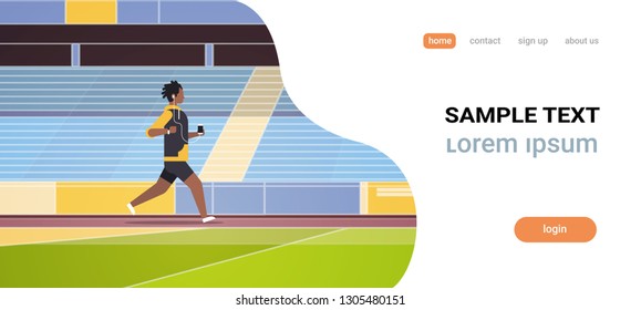 fitness man running stadium track african guy listening to music with headphones on smartphone healthy lifestyle concept tribunes background full length flat horizontal copy space