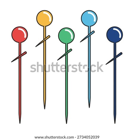 Five colorful sewing map tacks featuring round heads and sharp metal points stand upright against a plain white background ready for crafting or tailoring tasks.