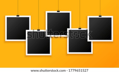 five hanging photo frames on yellow background