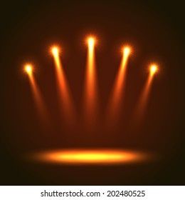 Five realistic bright orange projectors for scene lighting isolated on black background. Special light effects vector illustration